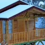 Arkada dağı olan çatıda karlar birikmiş veranda